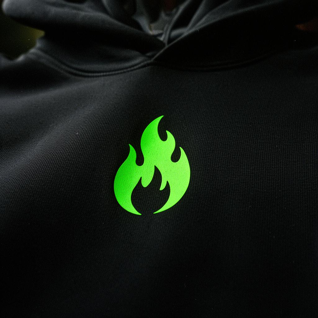 Close-up of neon green flame logo on black hoodie fabric